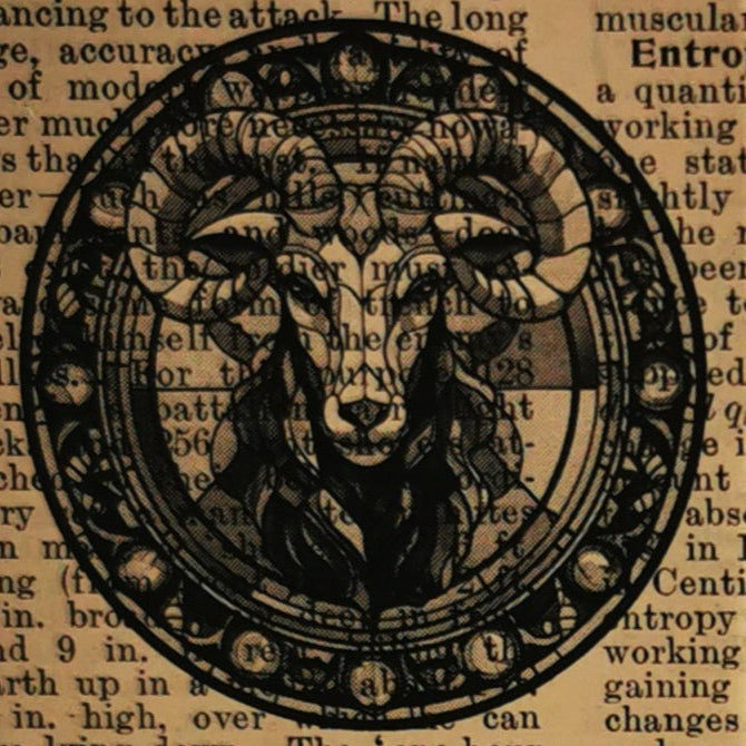 Card with Capricorn zodiac design and text next to a potted plant on a wooden surface.