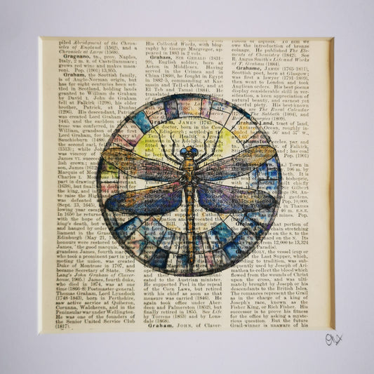 A watercolour and ink illustration of a dragonfly, crafted on a century-old encyclopaedia page, with visible text and aged patina.