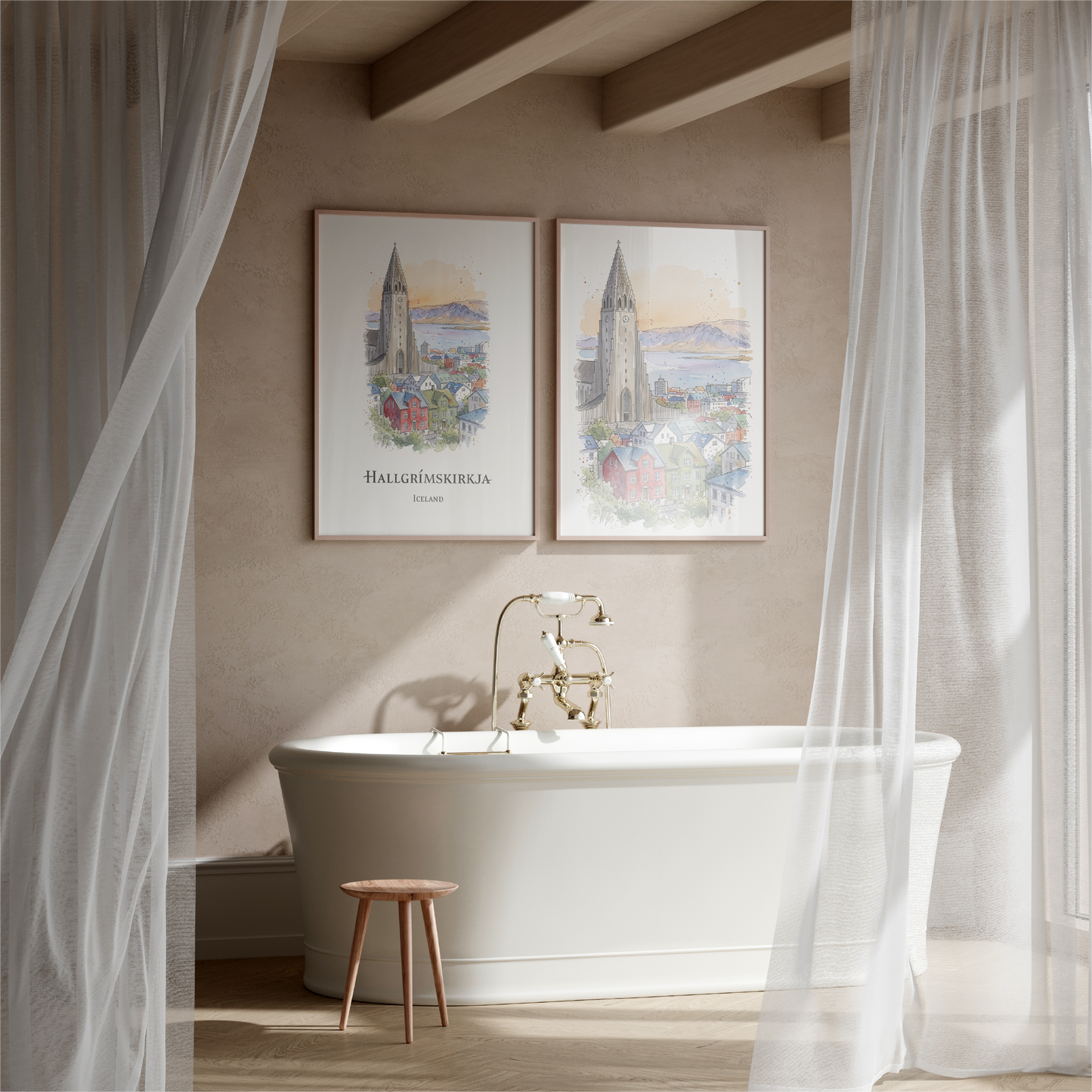 A styled bathroom scene with a white freestanding bathtub, gold faucet, sheer white curtains, and two framed vertical art prints hanging on the beige wall above the tub. The prints depict a church spire and a coastal city scene with the text 'HALLGRËUSKERJUN' and 'Iceland'.