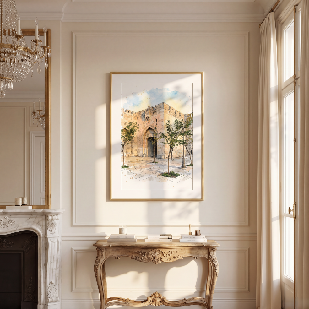 A framed watercolour painting of an old stone building with trees, displayed on a cream-coloured wall above a decorative console table in a classic interior setting.