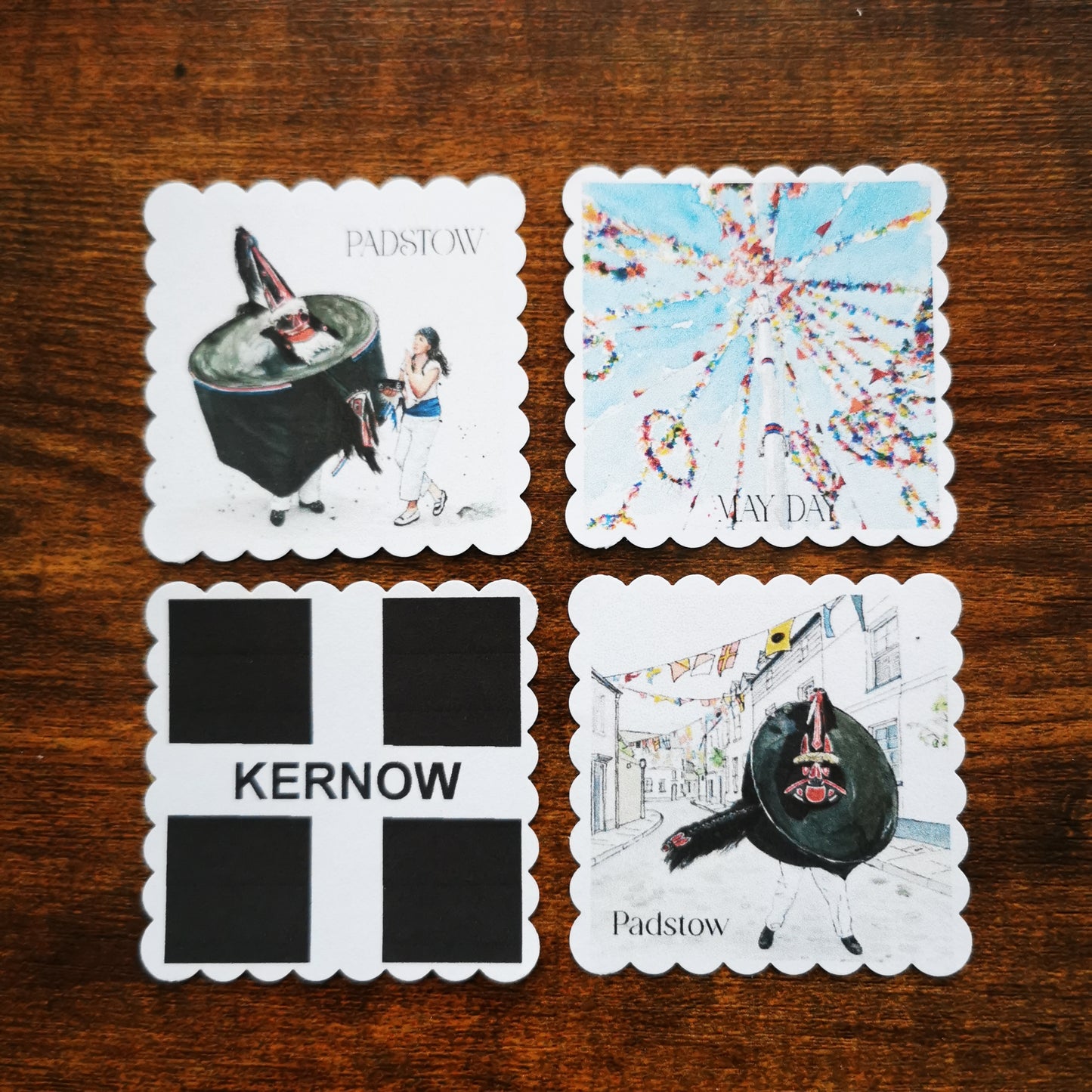Four faux postage stamps of Padstow May  Day  on a wooden surface