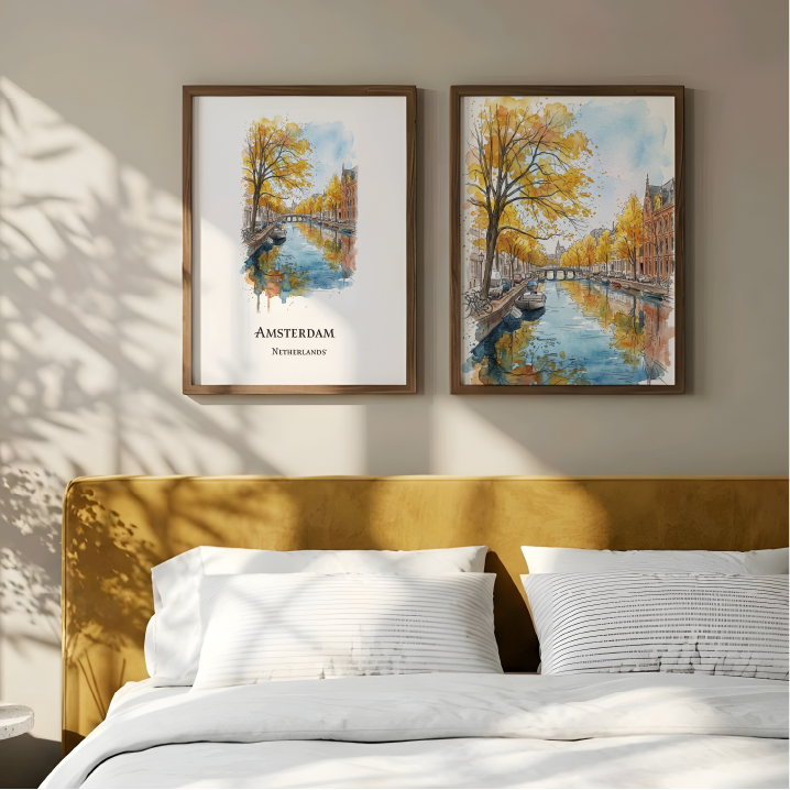 Two framed Amsterdam watercolour prints with yellow autumn trees and blue canal reflections, displayed above a bed with a mustard yellow headboard in a styled bedroom.