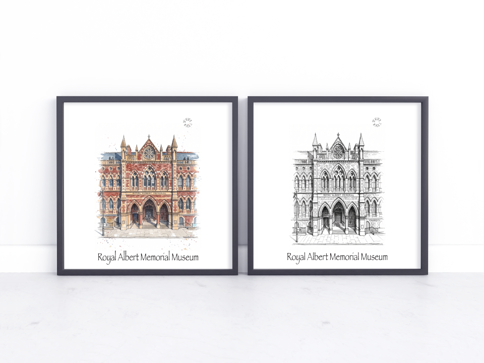 Two framed art prints of the Royal Albert Memorial Museum in Exeter, one in a watercolour style with warm red-brown tones and one in black and white line art, displayed side-by-side on a white surface against a white wall.
