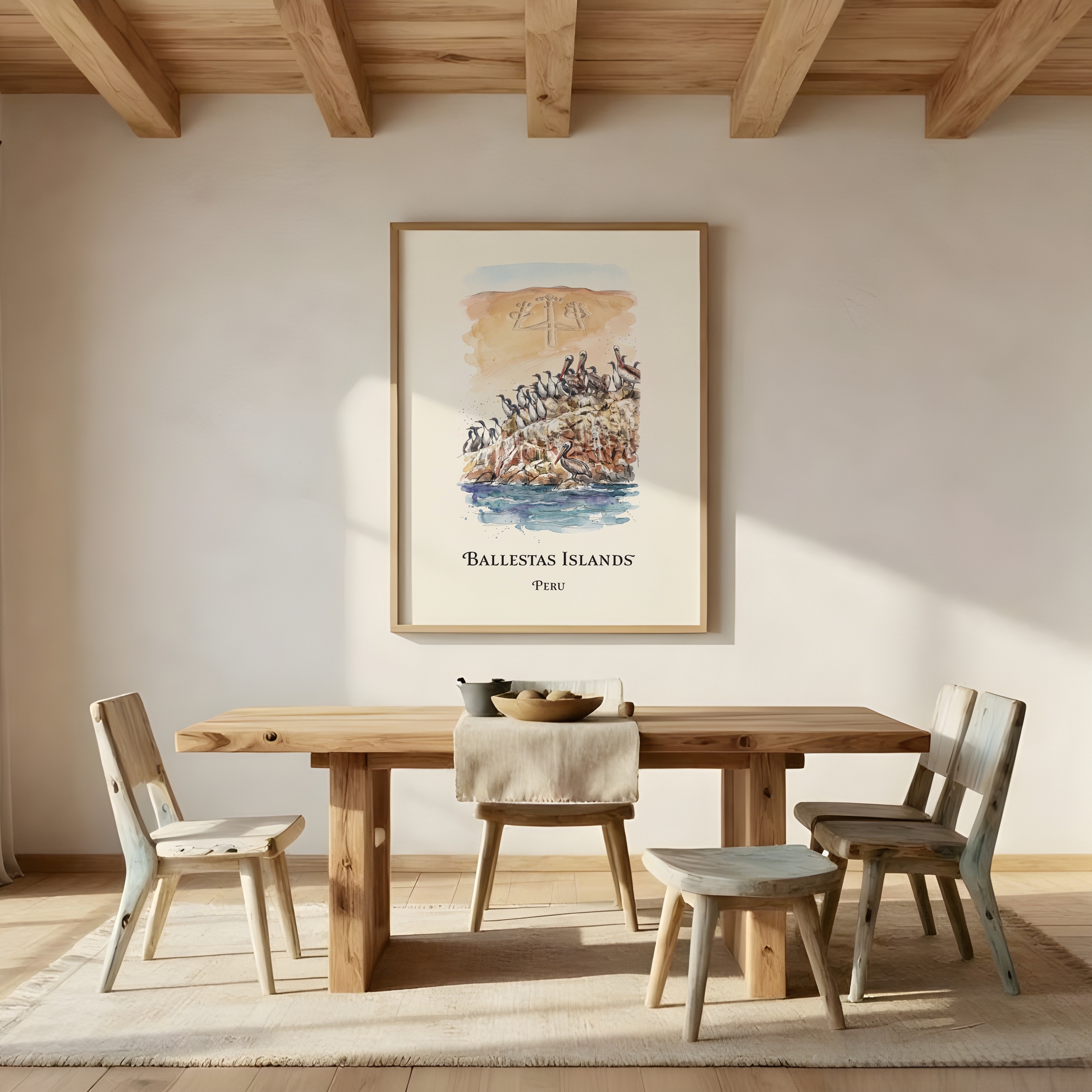 A framed art print of 'The Balesstans Islands' hangs on a warm beige wall in a beautifully styled dining room with a wooden table, chairs, and a view of the ocean through an arched doorway.