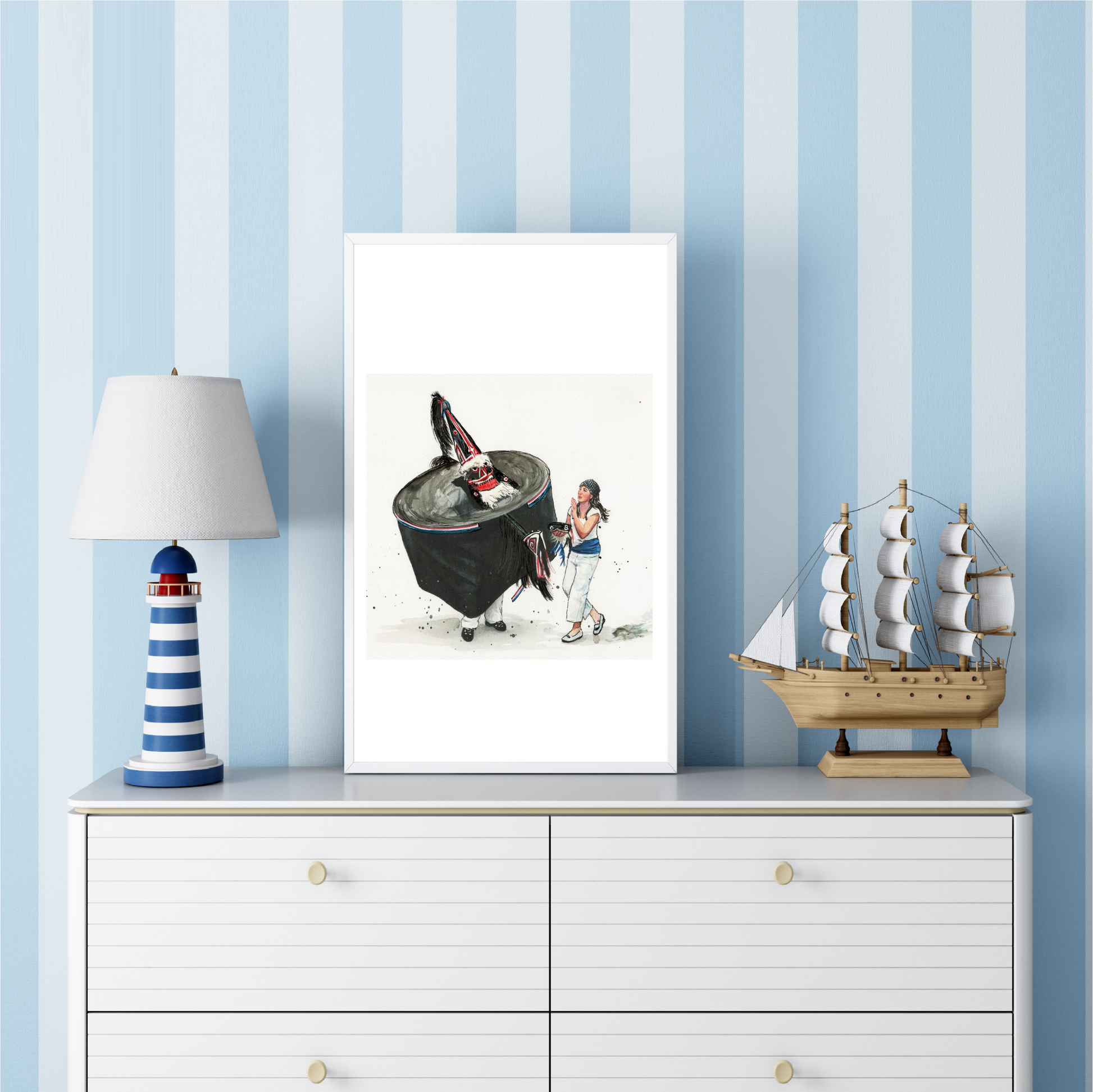 Padstow Blue Obby Oss watercolour travel poster in a frame on a white dresser with striped blue wallpaper