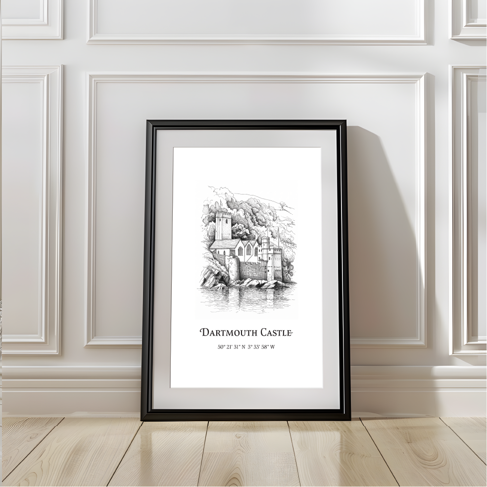 A framed black-and-white art print of Dartmouth Castle leaning against a white paneled wall on a light wood floor.