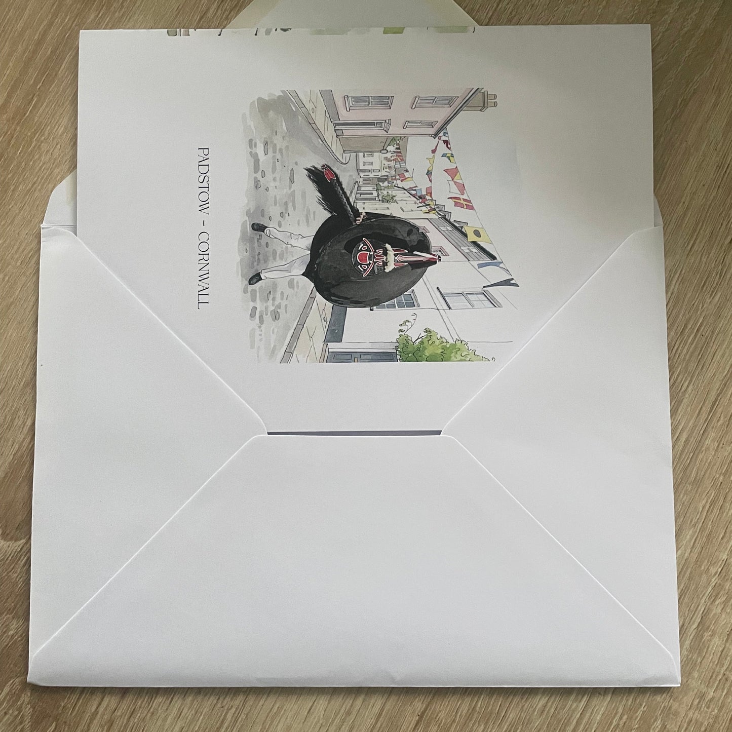 Folded a5 8 Page Letter home about Padstow with text, watercolour images, and illustrations on a white background in an airmail envelope