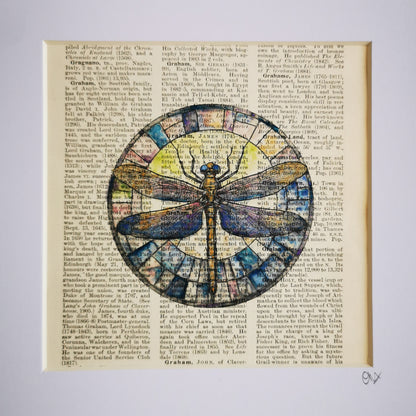 A watercolour and ink illustration of a dragonfly, crafted on a century-old encyclopaedia page, with visible text and aged patina.