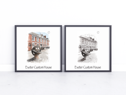 Two framed art prints leaning against a white wall on a light surface. Each print shows an architectural illustration of Exeter Custom House with one print featuring a muted watercolour red brick building and the other in black and white.