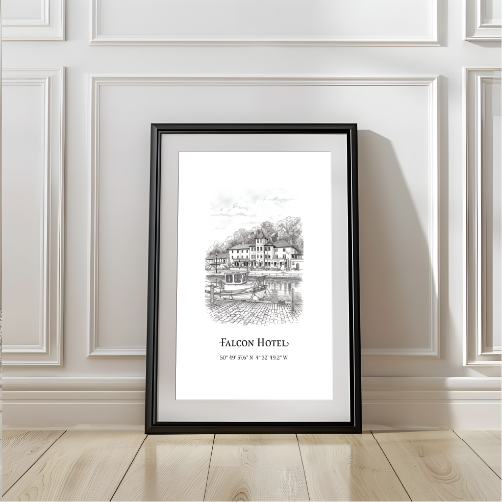 A framed black-and-white architectural print of the Falcon Hotel leaning against a white paneled wall on a light wood floor.