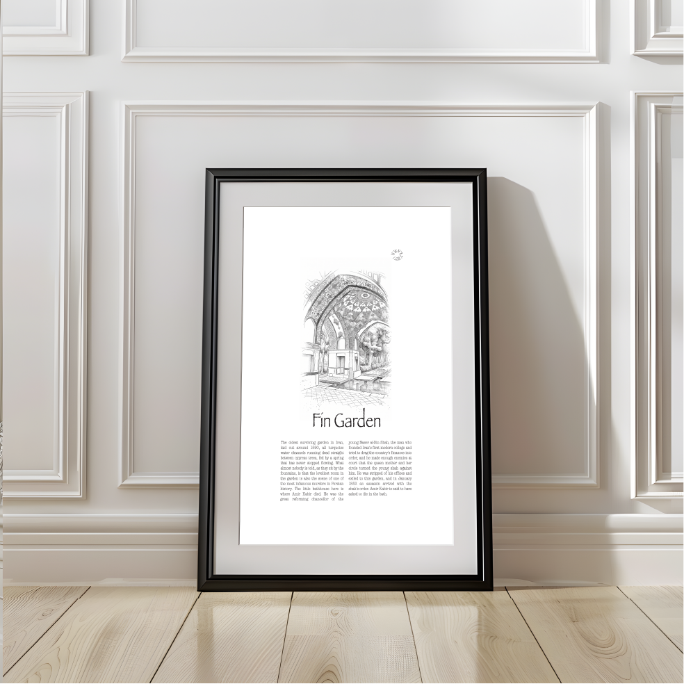 A framed black and white art print titled 'Fin Garden' leaning against a white paneled wall on a light wood floor.