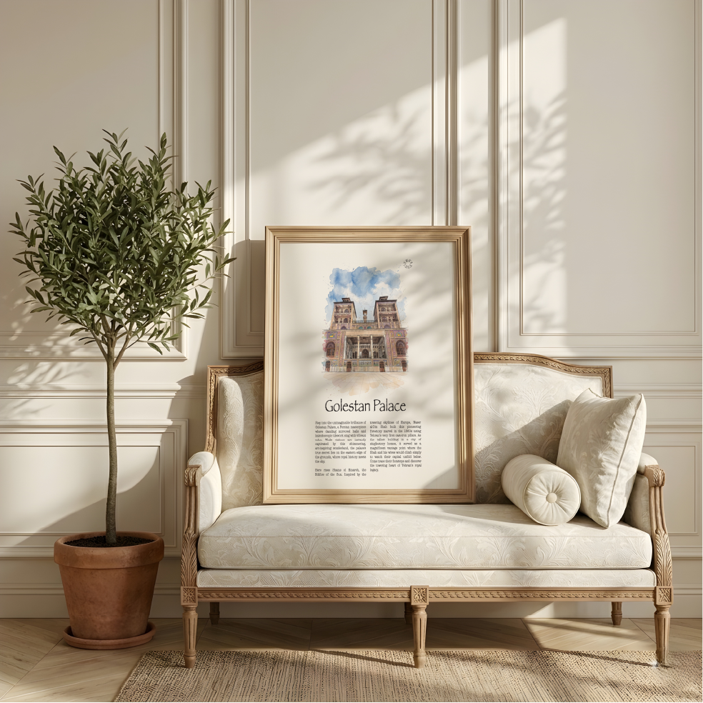 A framed art print of Golestan Palace leaning against a cream-colored sofa in a beautifully styled room with a potted olive tree and warm sunlight.
