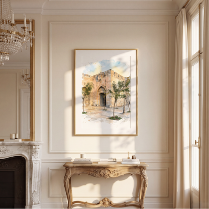 A framed watercolour painting of an old stone building with trees, displayed on a cream-coloured wall above a decorative console table in a classic interior setting.