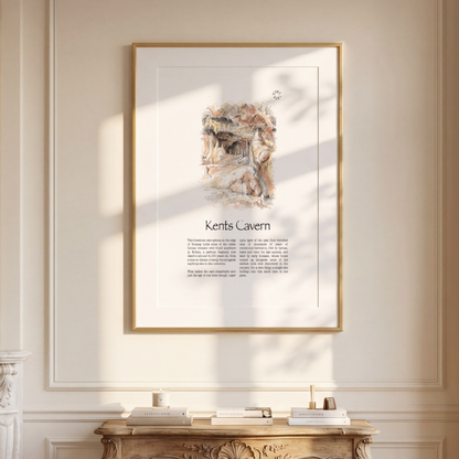 A framed art print featuring an illustration and the text 'Kents Cavern' on a cream-coloured wall in a beautifully decorated room with a gold console table, a mirror, and a window.