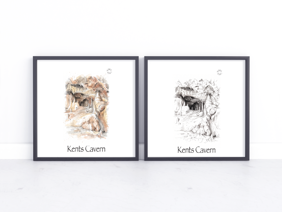 Two framed art prints leaning against a white wall on a light surface. The left print shows a coloured sketch of Kents Cavern with warm earthy tones, and the right print shows a black-and-white sketch of the same cave scene.