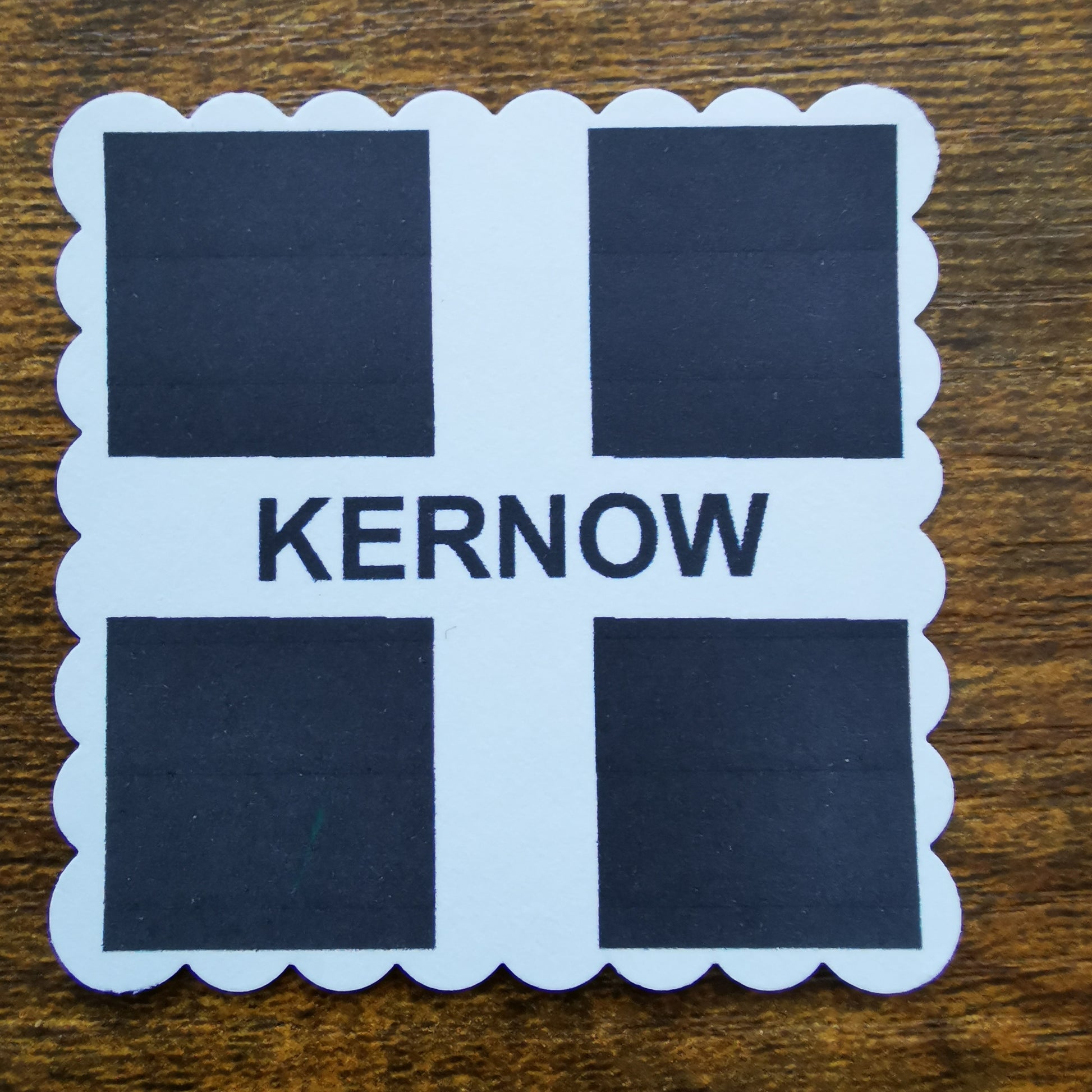 Faux postage stamp Sticker with 'Kernow' text on a wooden surface