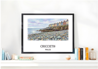Framed artwork of Marine Terrace in Criccieth, Wales on a shelf with books and decor.
