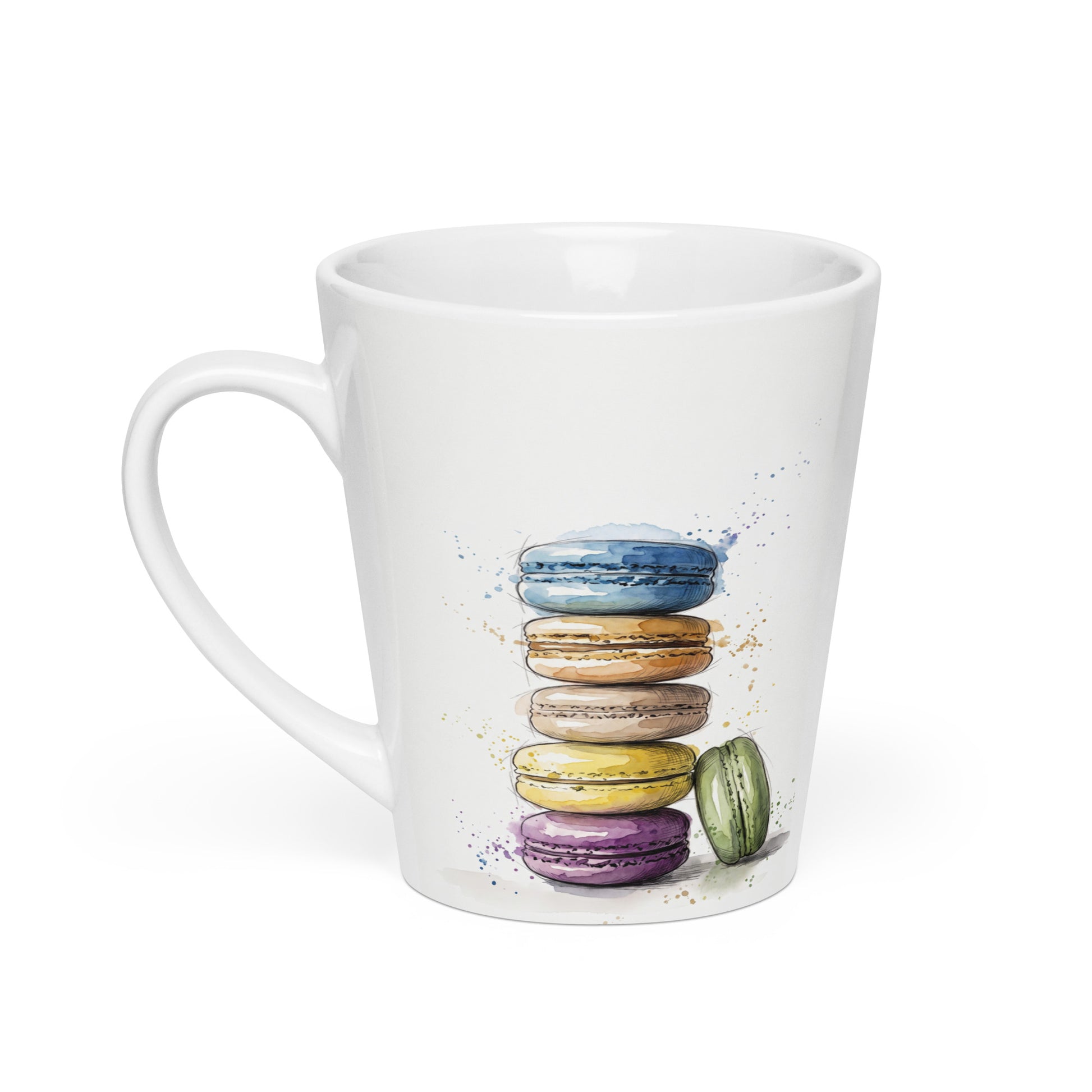 A white ceramic latte mug featuring a watercolour illustration of a stack of colorful macarons in blue, orange, brown, yellow, purple, and green, set against a plain white background, handle on the left.