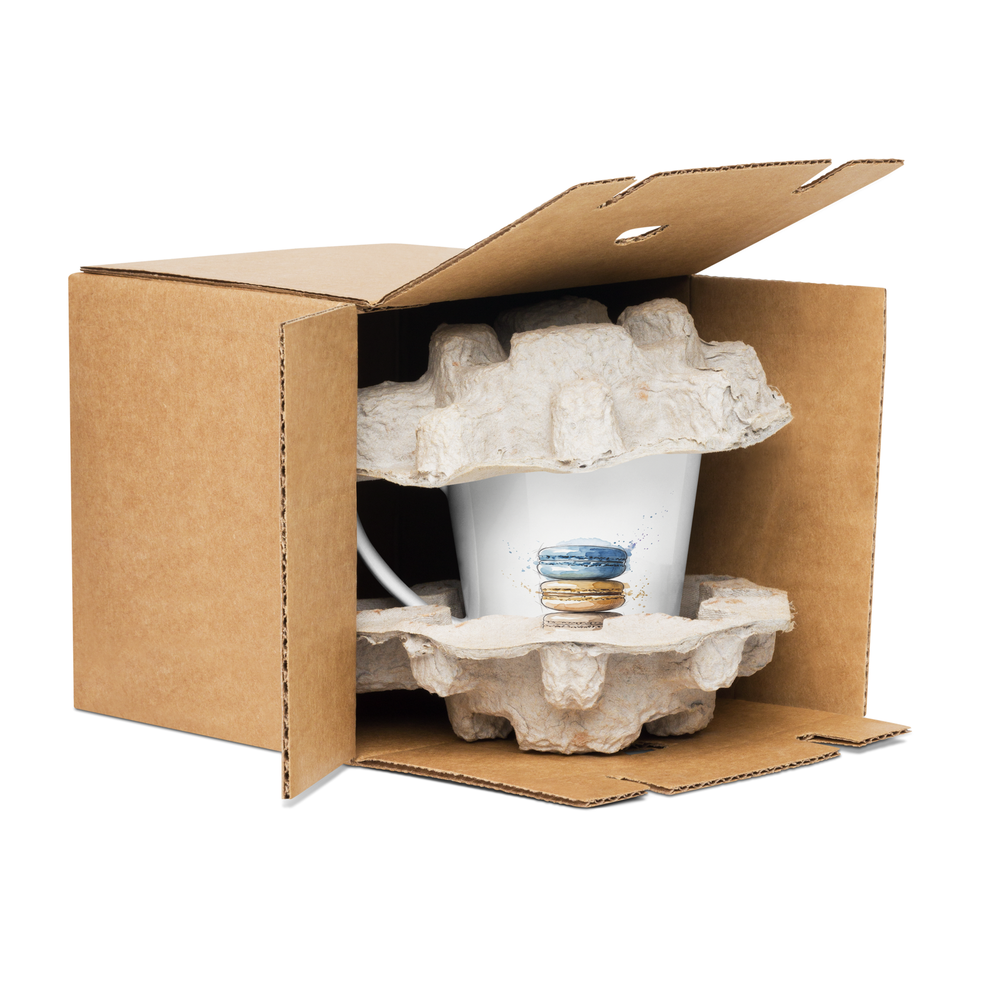 A white ceramic mug with a blue and orange watercolour print of a stack of macarons, nestled inside a brown cardboard box with protective foam inserts, isolated on a white background.