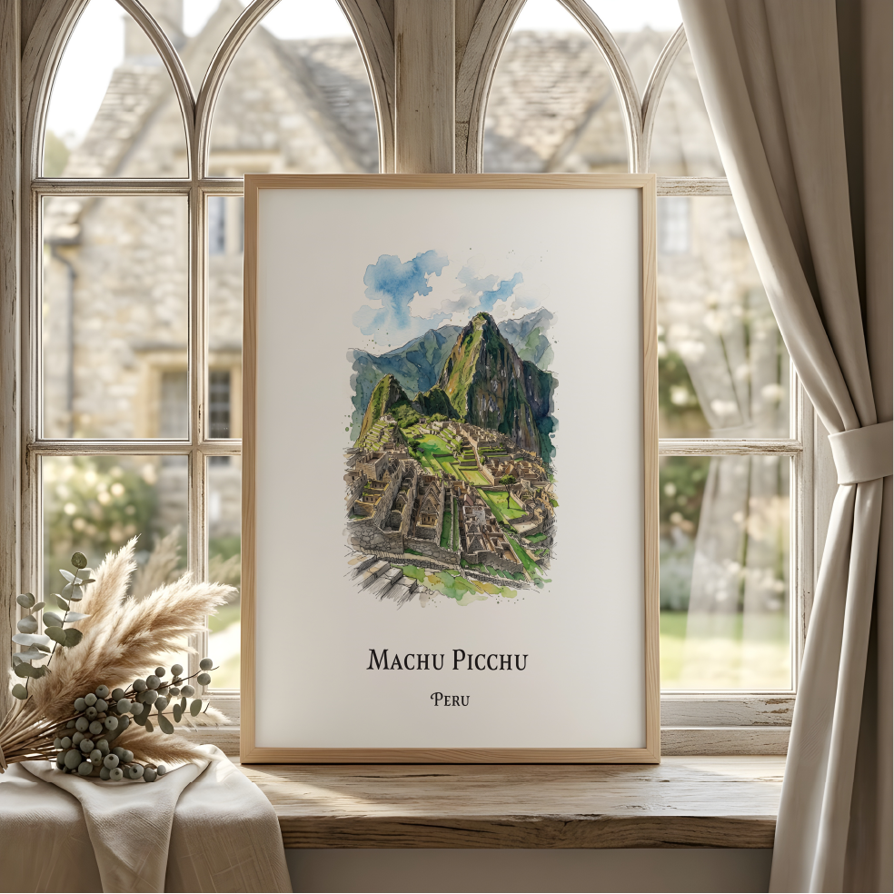 A framed art print of Machu Picchu, Peru, leaning against a window on a wooden ledge. The print features a watercolor illustration of the ancient ruins with green terraces and a blue sky, set in a light wood frame.