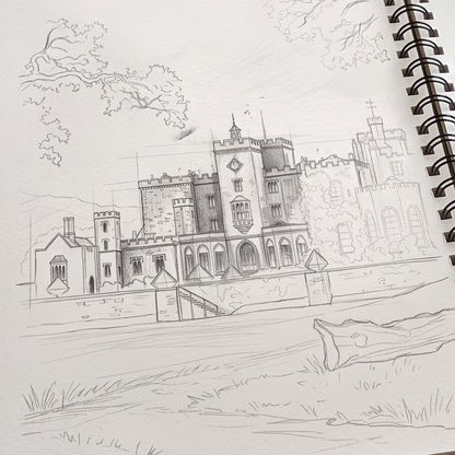A pencil sketch of Powderham Castle drawn in a spiral notebook with visible spiral binding on the right side.
