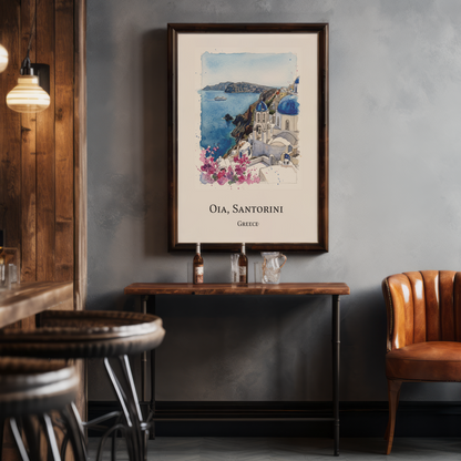 A framed travel poster of Oia, Santorini, Greece, hanging on a textured grey wall in a rustic cafe setting with wooden tables, chairs, and hanging pendant lights.
