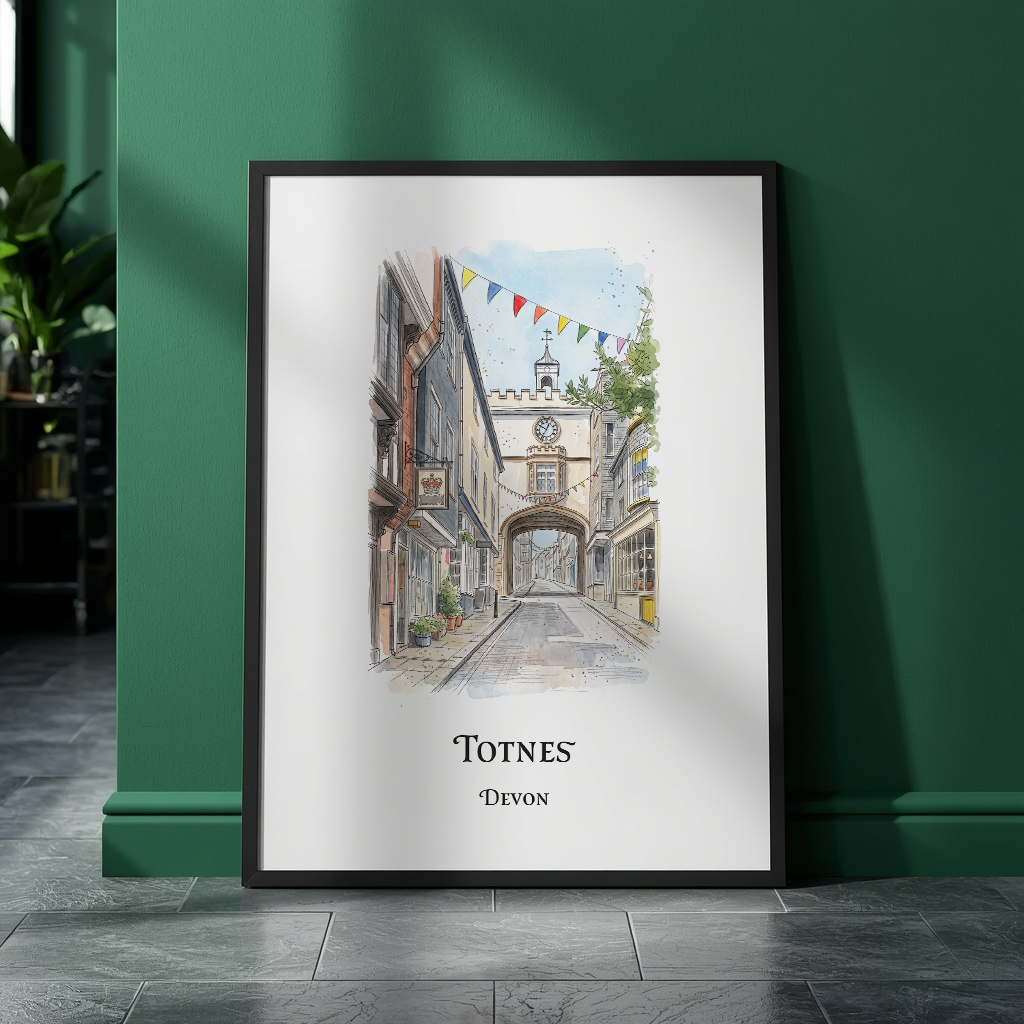 A framed watercolour art print of a cobbled street scene labeled 'TOTNES DEVON' leans against a dark green wall on a grey tiled floor.