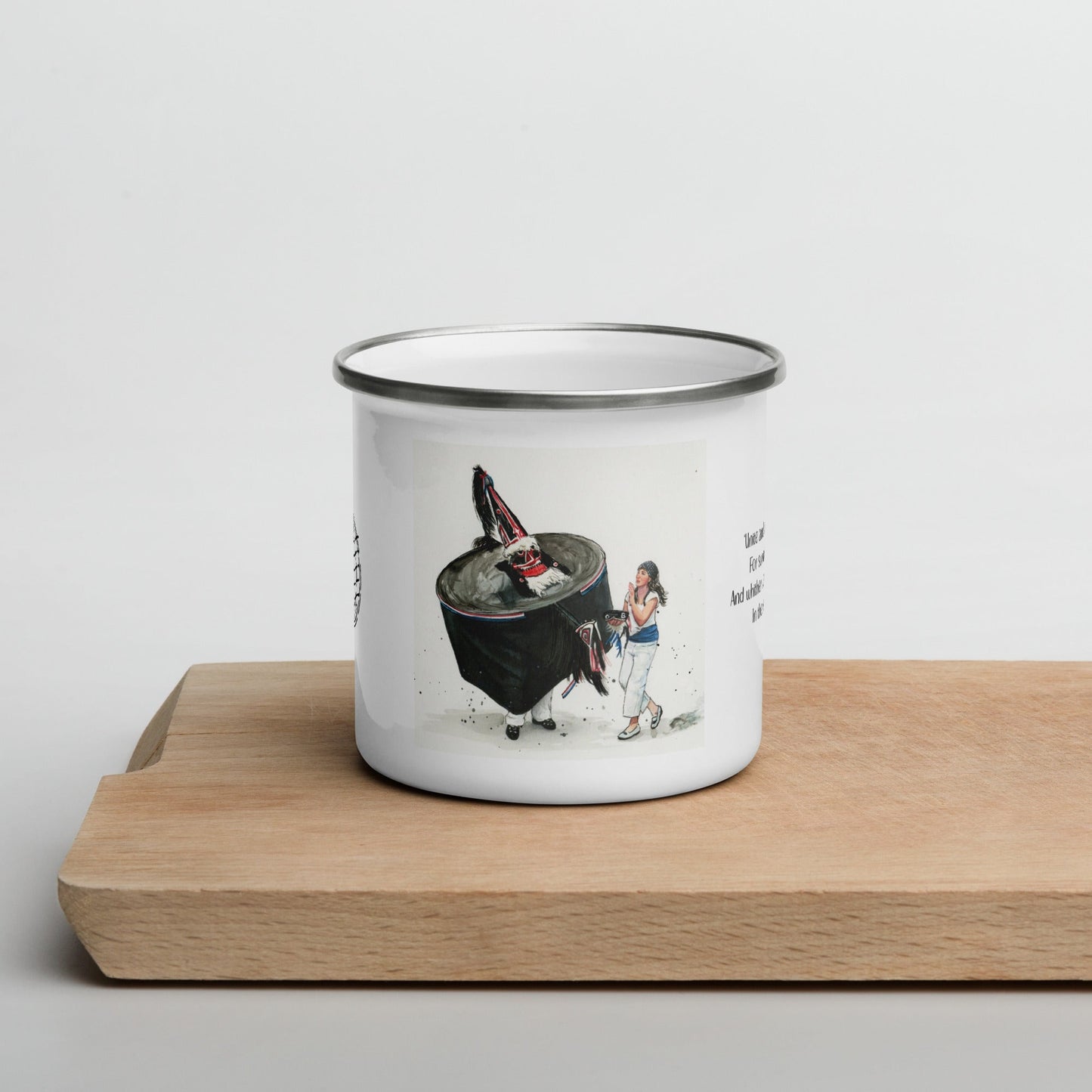 Enamel mug with a design on a wooden surface
